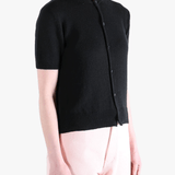 Black knitwear worn by a person, showing the knitwear's fit