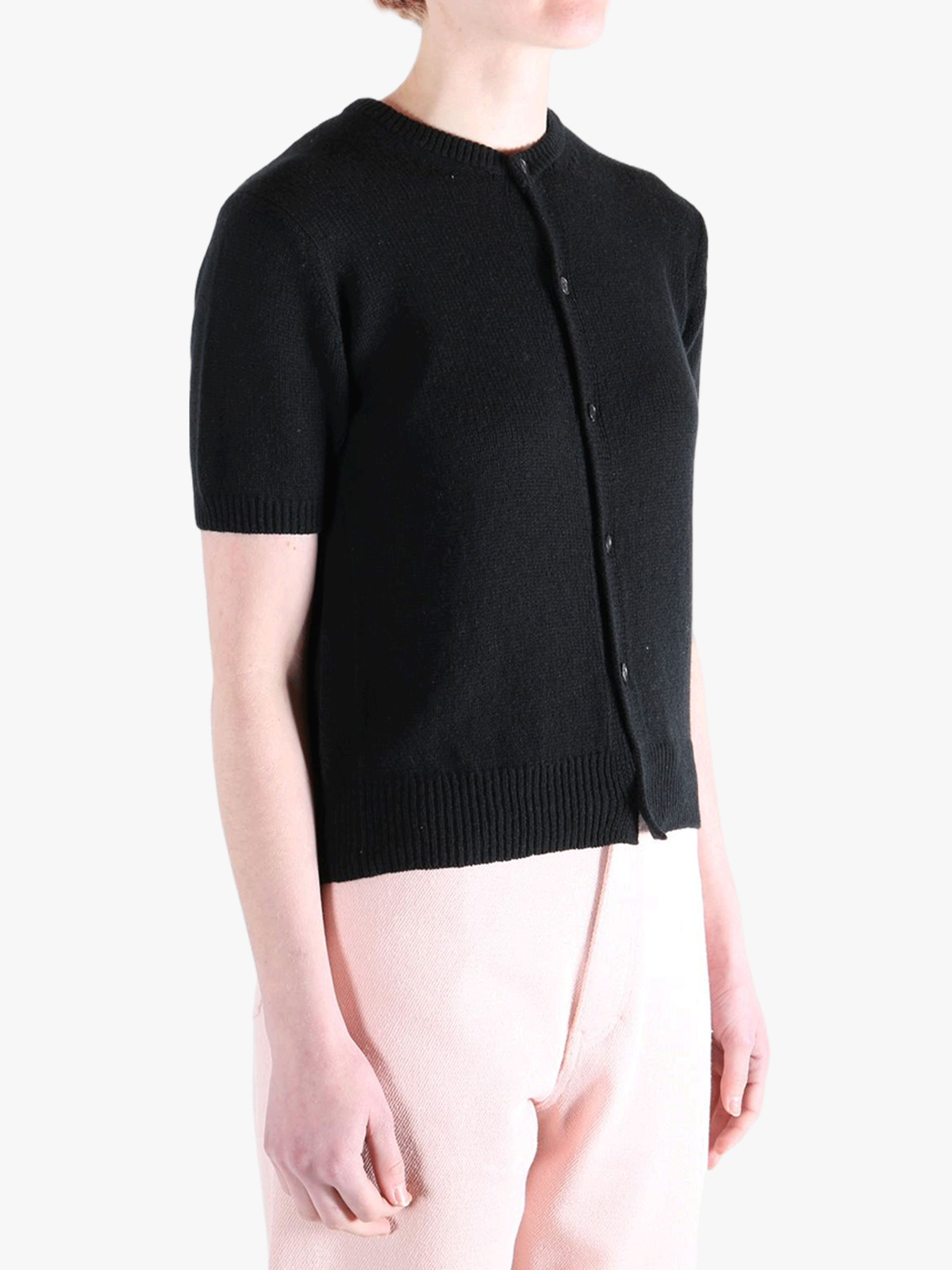 Black knitwear worn by a person, showing the knitwear's fit