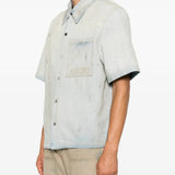 Blue shirt worn by a person, showing the shirt fit
