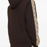 Brown hoodie worn by a person, showing the hoodie's fit