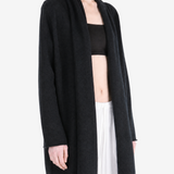 Black knitwear worn by a person, showing the knitwear fit