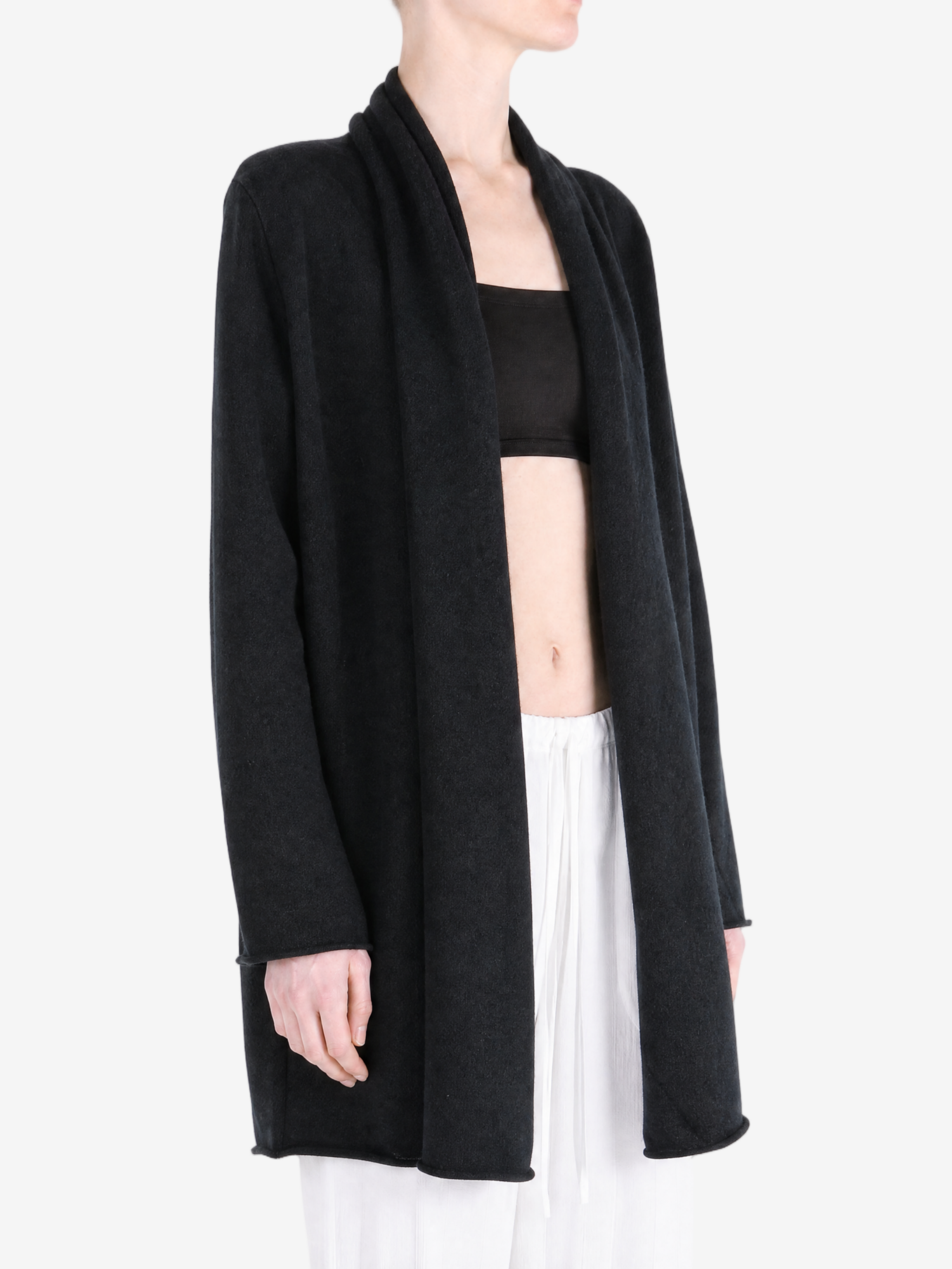 Black knitwear worn by a person, showing the knitwear fit