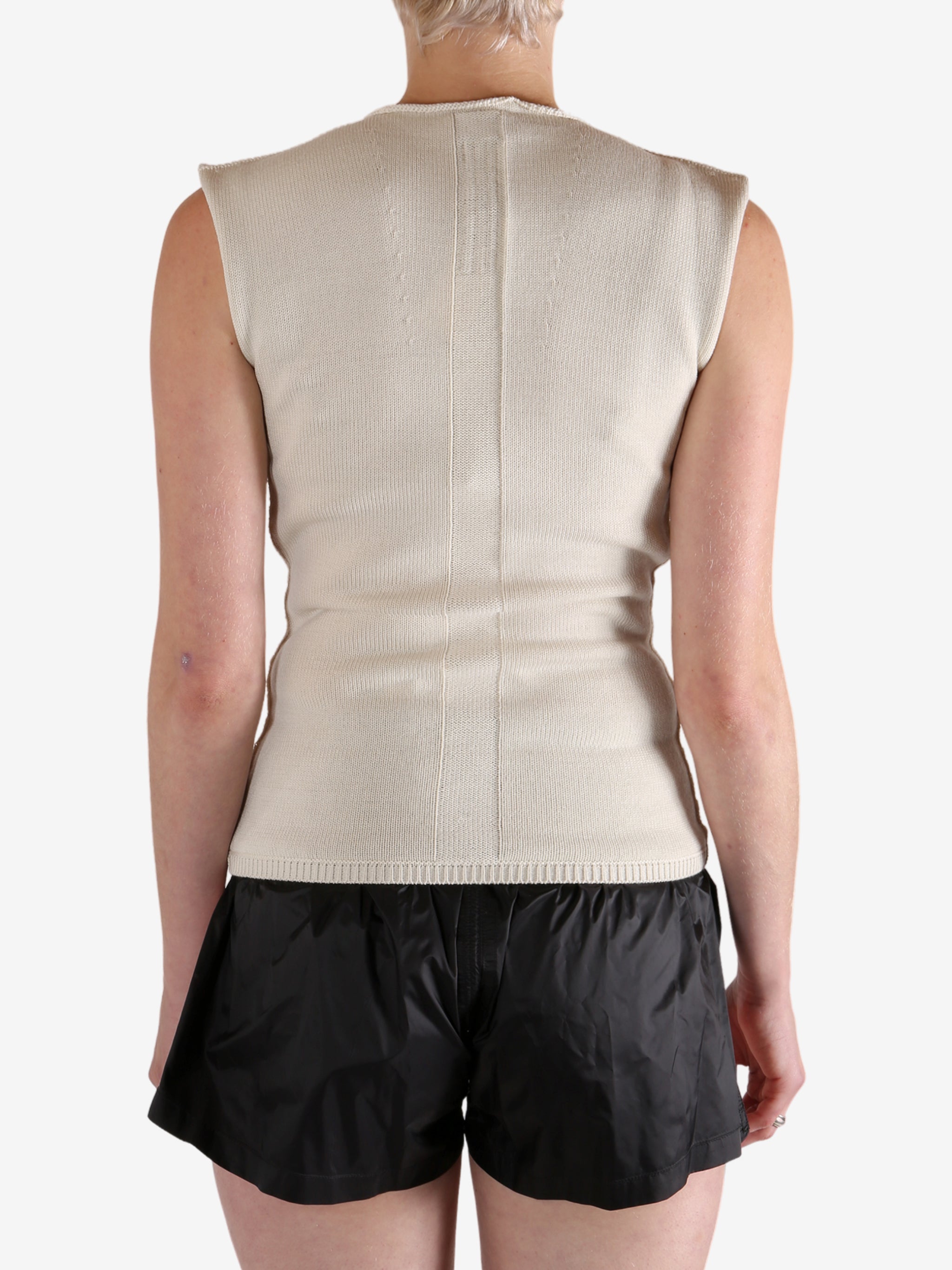 White top worn by a person, showing the top's fit