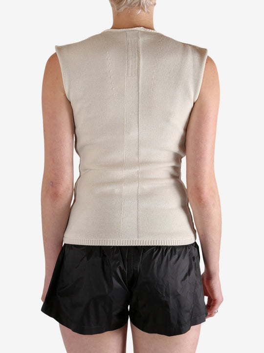 White top worn by a person, showing the top's fit