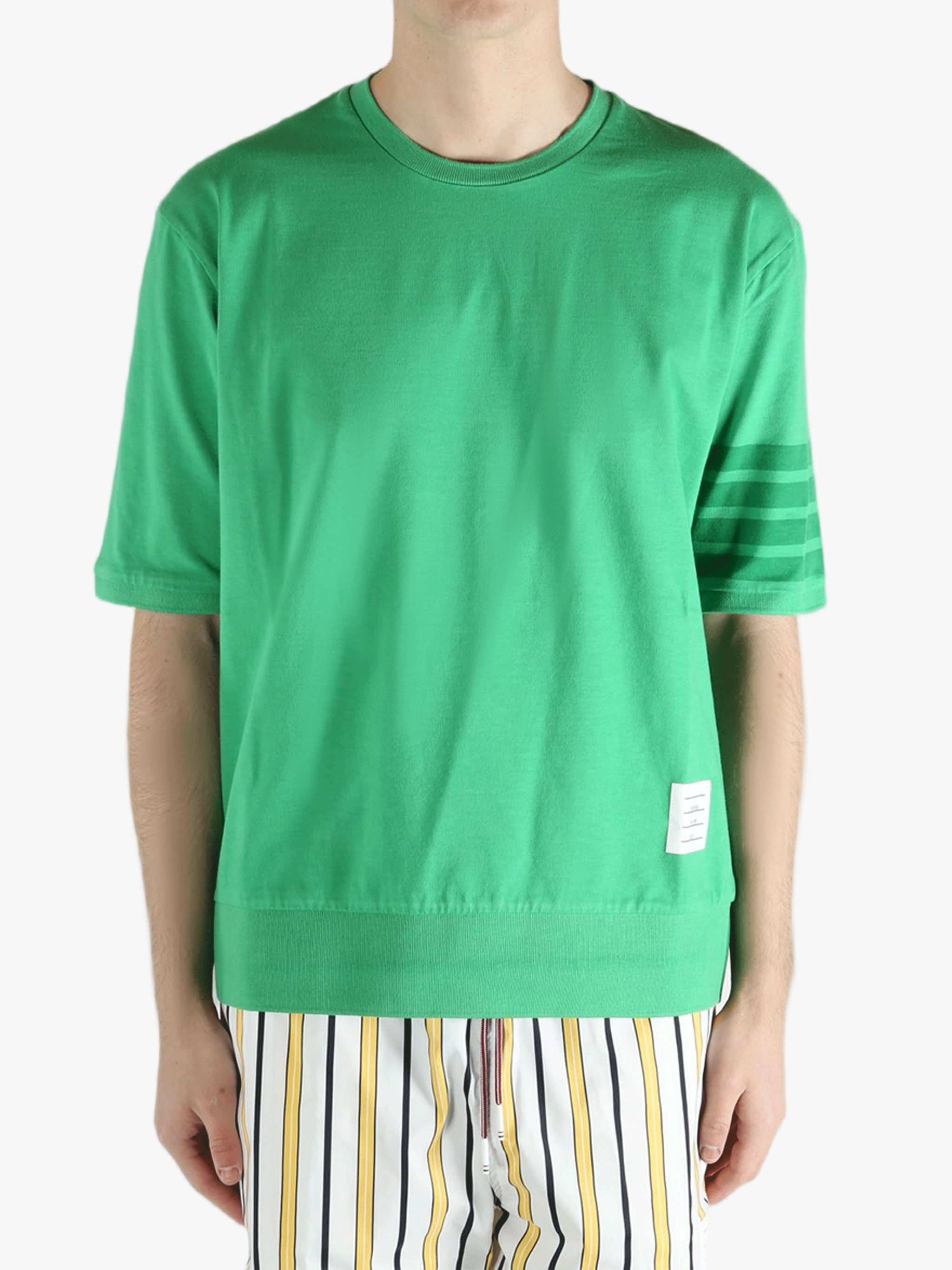 Green t-shirt worn by a person, showing the shirt's fit