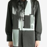 Black coat worn by a person, showing the coat's fit