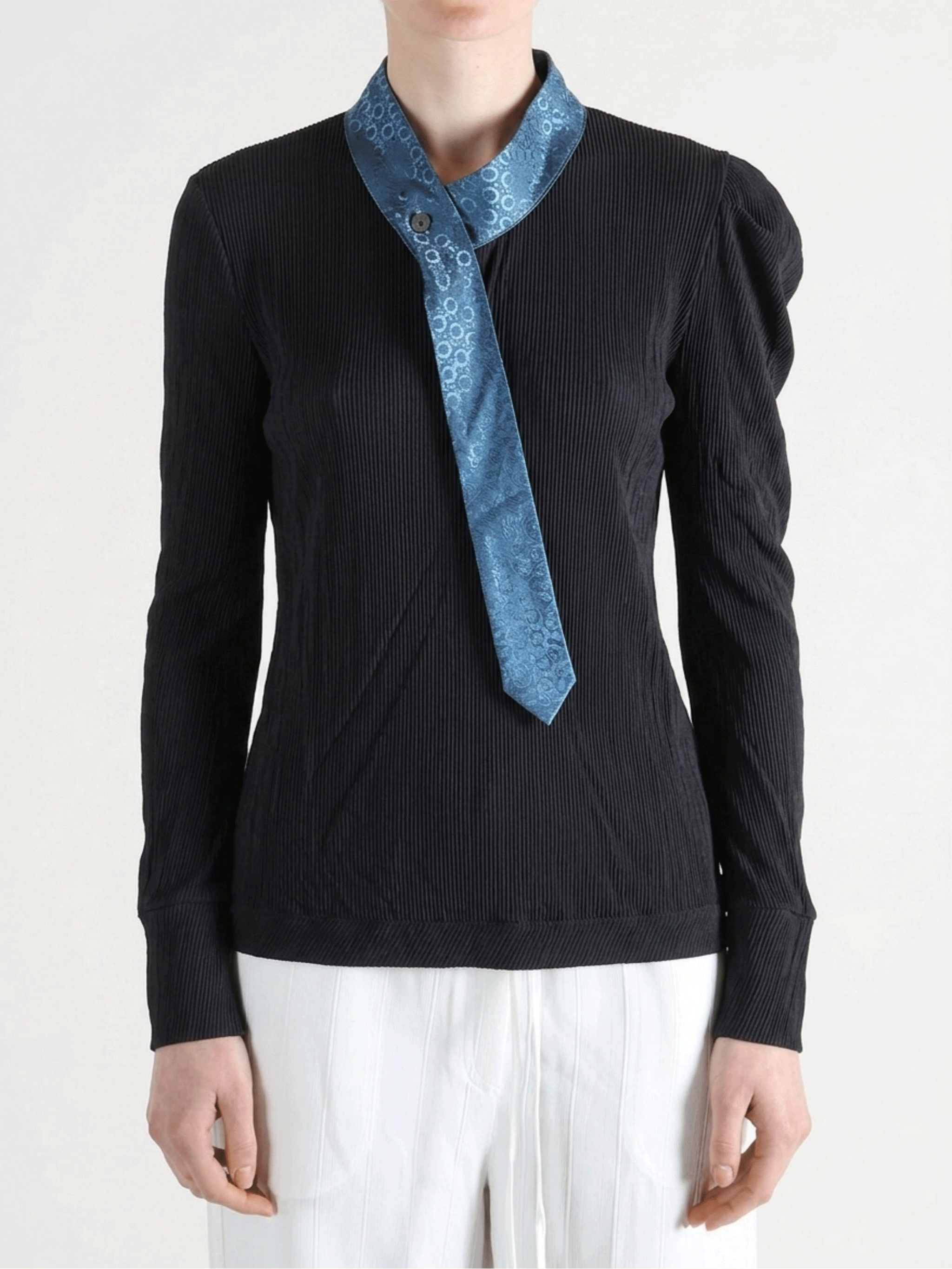 Black shirt worn by a person, showing the shirt fit