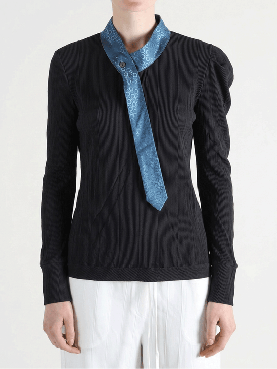 Black shirt worn by a person, showing the shirt fit