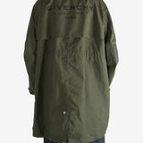 Green coat worn by a person, showing the coat fit