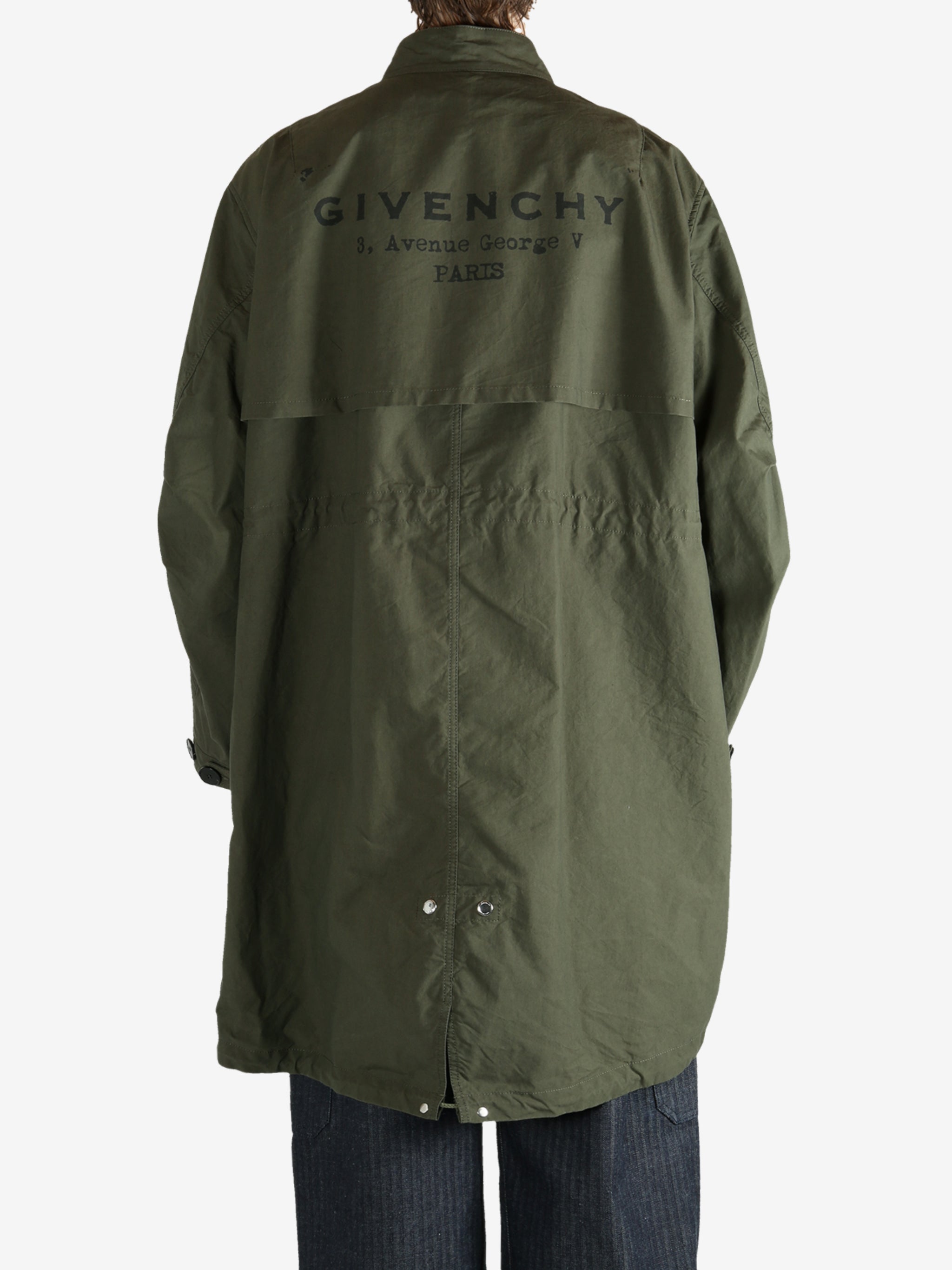 Green coat worn by a person, showing the coat fit