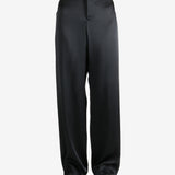 Black pants worn by a person, showing the pants' fit