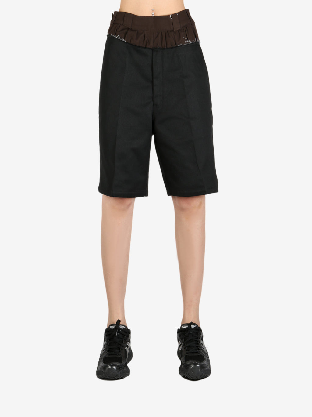 Black pants worn by a person, showing the pant’s fit