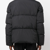 Black coat  worn by a person, showing the coat's fit