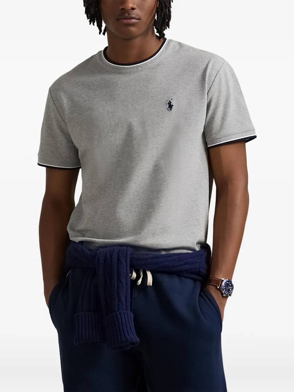 Grey T-shirt worn by a person, showing the T-shirt's fit