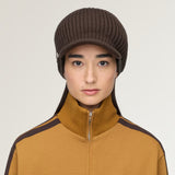 Brown hat worn by a person, showing the hat fit