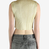 green pleated top worn by a person, showing the top fit