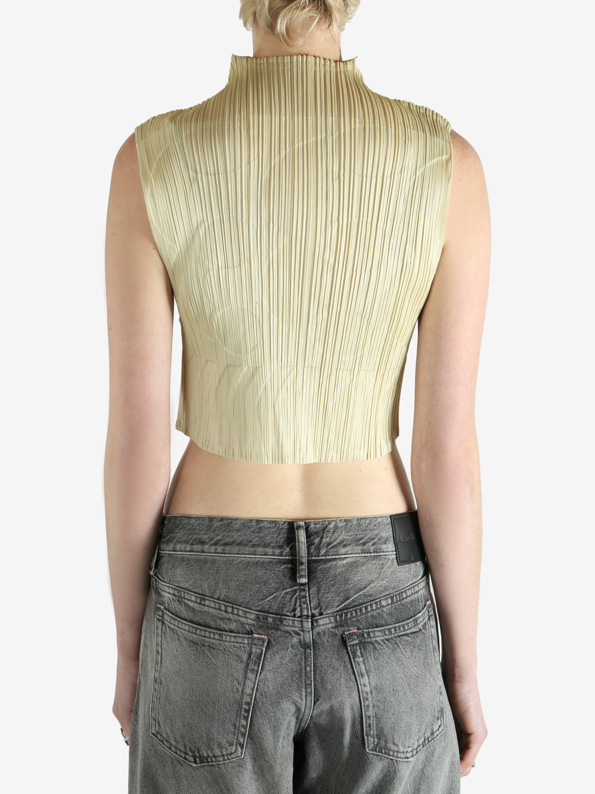 green pleated top worn by a person, showing the top fit