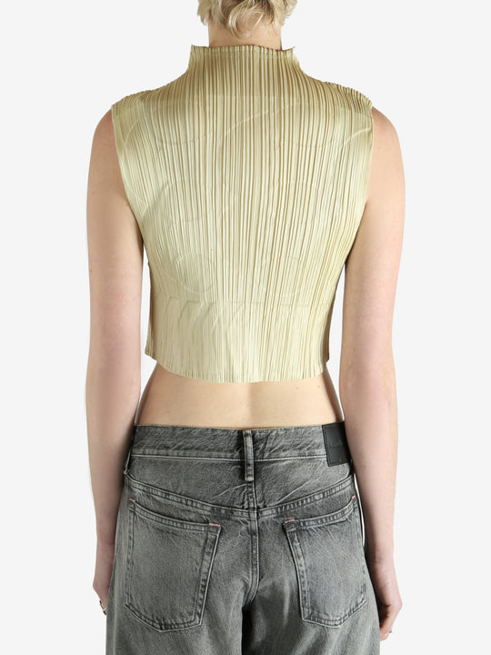 green pleated top worn by a person, showing the top fit