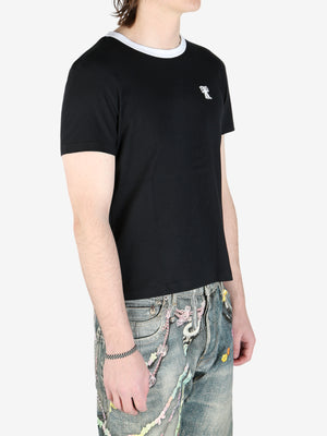 Black t-shirts worn by a person, showing the t-shirt's fit