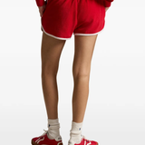 Red short worn by a person, showing the short's fit