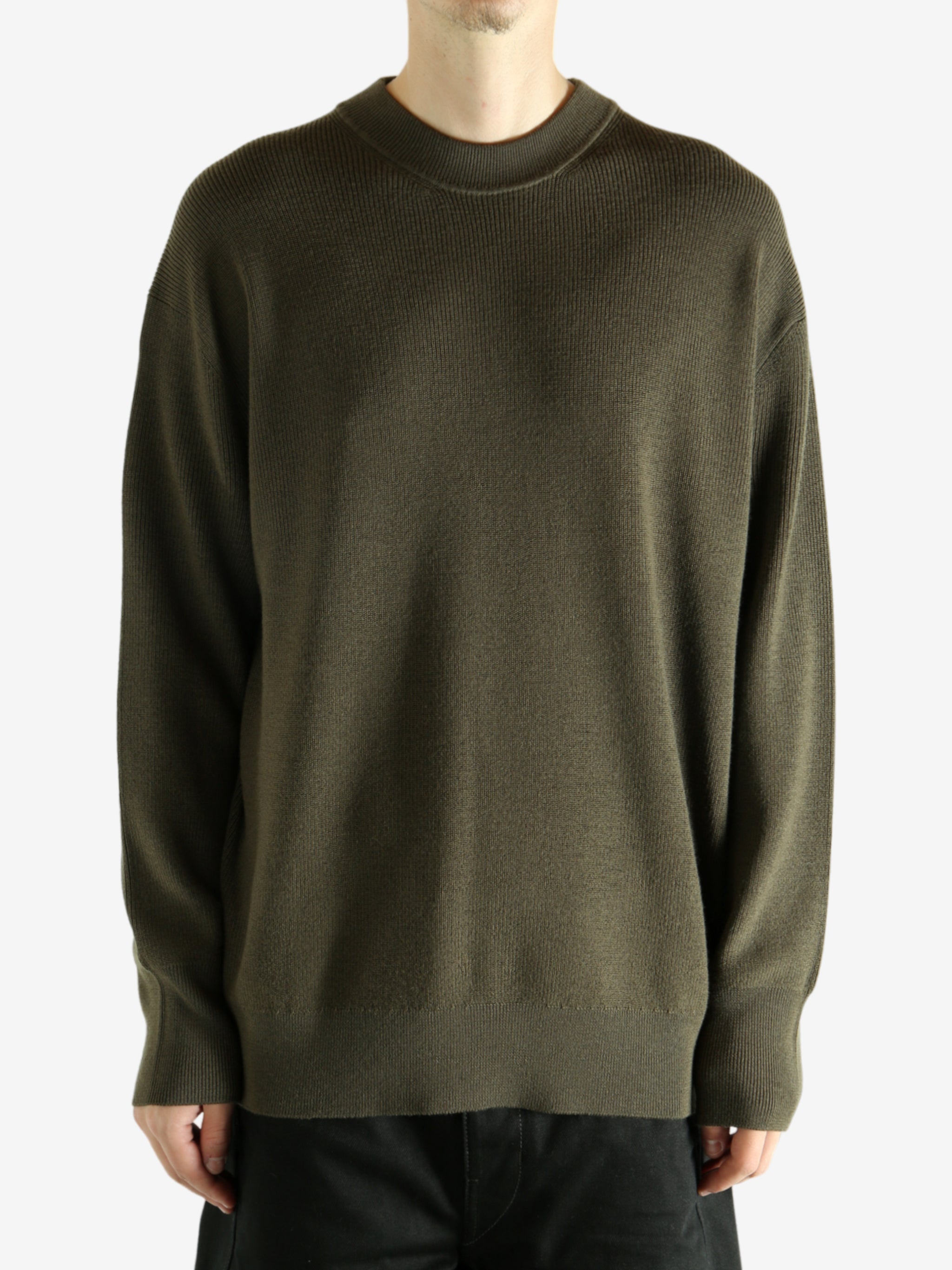 Crew knitwear worn by a person, showing the knitwear's fit