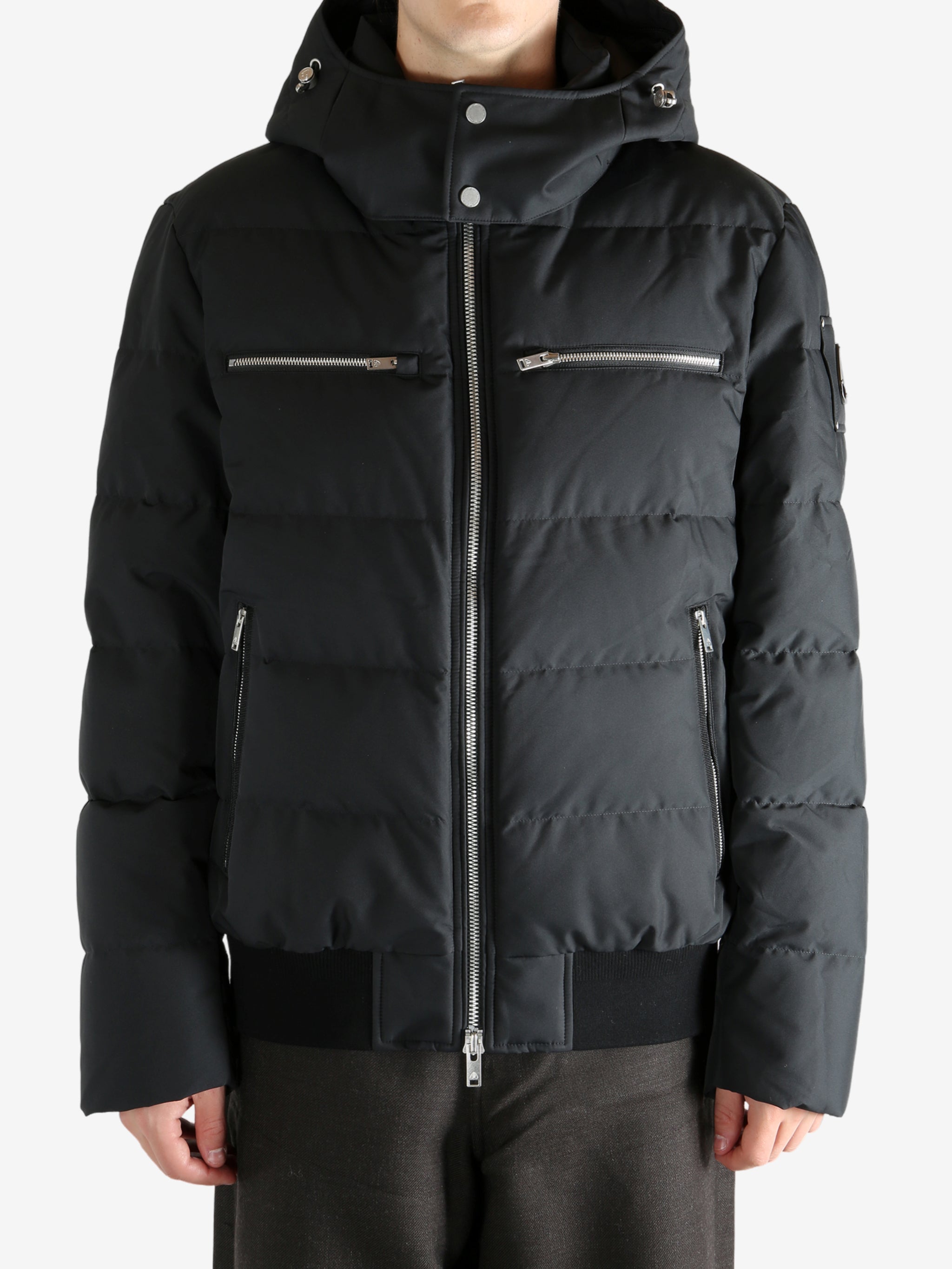 Black coat worn by a person, showing the coat's fit