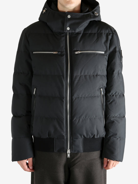 Black coat worn by a person, showing the coat's fit