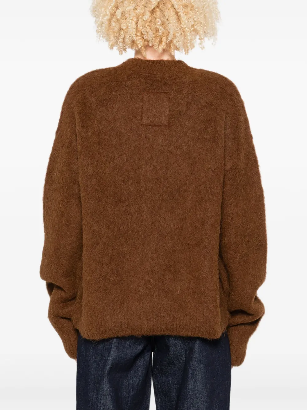 Brown sweater worn by a person, showing the sweater fit