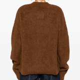 Brown sweater worn by a person, showing the sweater fit