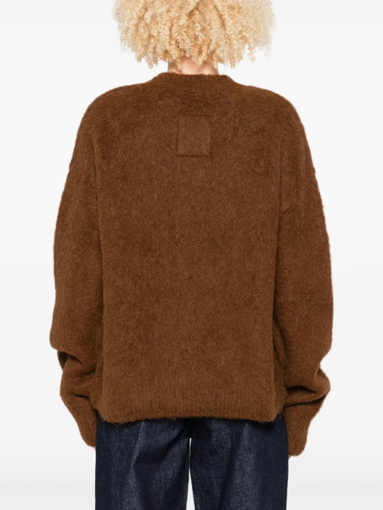 Brown sweater worn by a person, showing the sweater fit