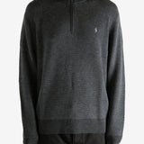 Grey knitwear worn by a person, showing the knitwear's fit