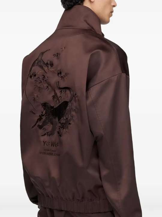 Close up of brown jacket, showing texture of the recycled polyester fabric