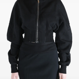 Black hoodie worn by a person, showing the  hoodie fit