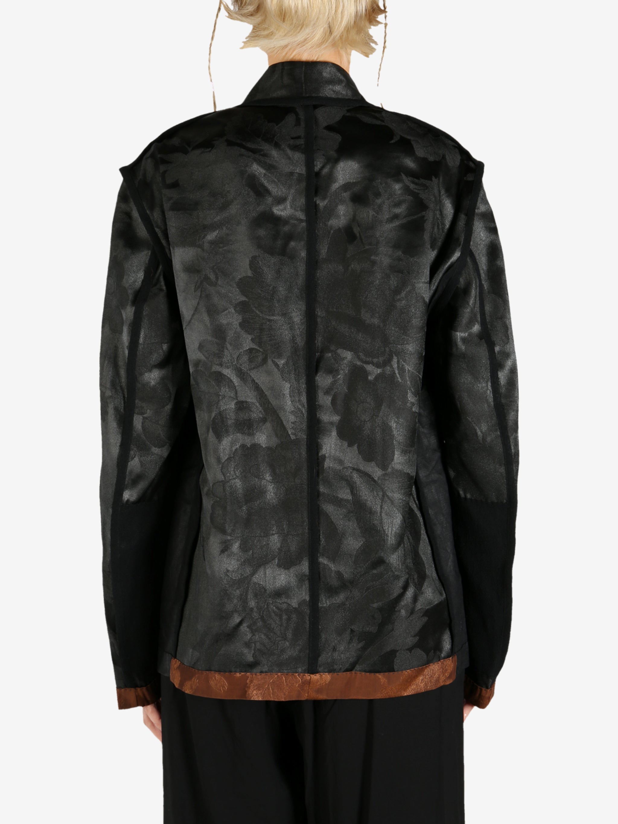 Black jacket worn by a person, showing the jacket's fit