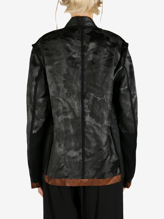 Black jacket worn by a person, showing the jacket's fit