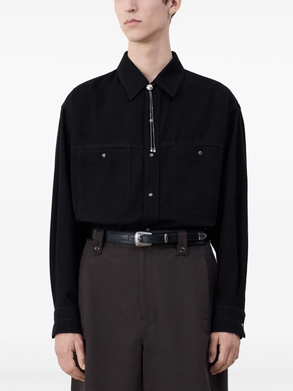 Black belt worn by a person, showing the belt fit