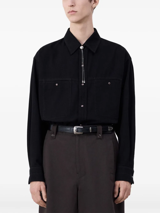 Black belt worn by a person, showing the belt fit