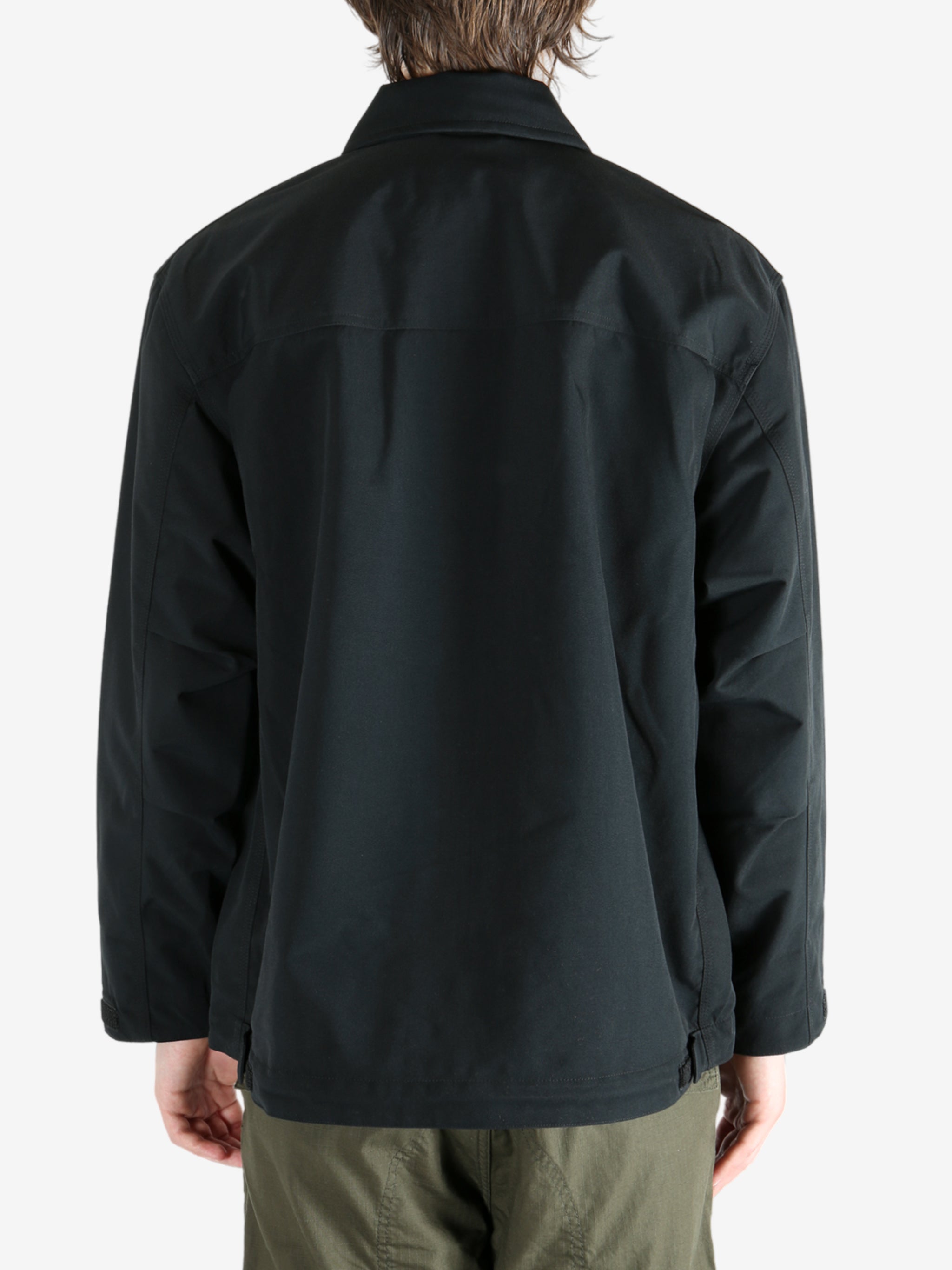 Black jacket worn by a person, showing the jacket's fit