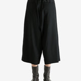 Black pants worn by a person, showing the pants fit