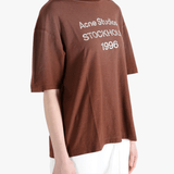 Brown t-shirt worn by a person, showing the t-shirt fit