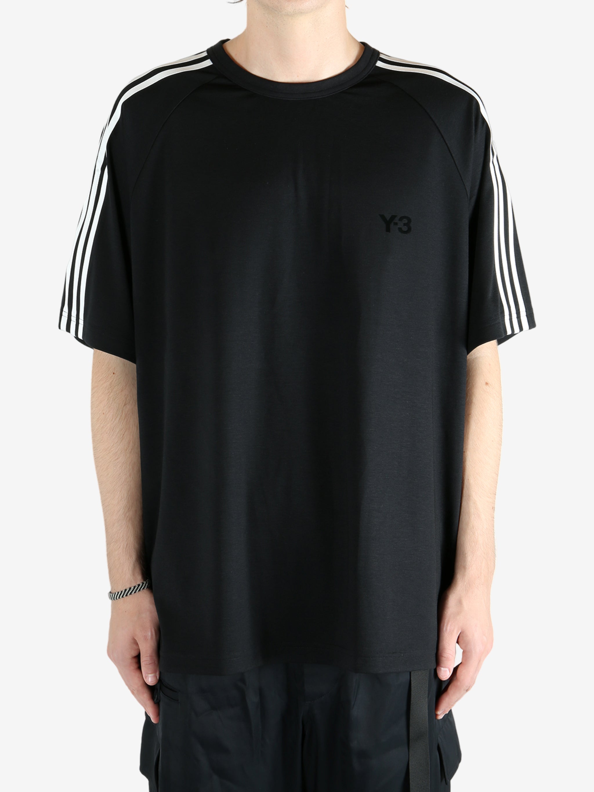 Black t-shirt worn by a person, showing the shirt's fit