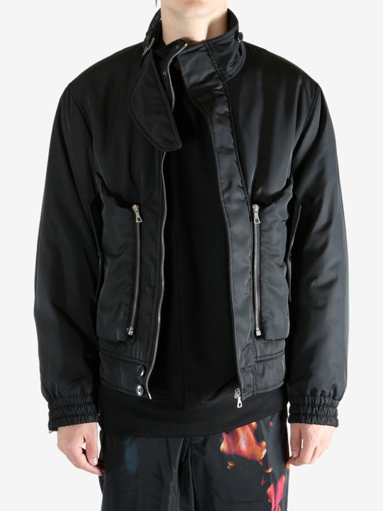 Black jacket worn by a person, showing the jacket's fit
