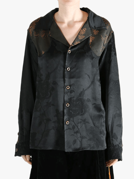 Black shirt worn by a person, showing the shirt's fit