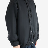Black jacket worn by a person, showing the jacket's fit