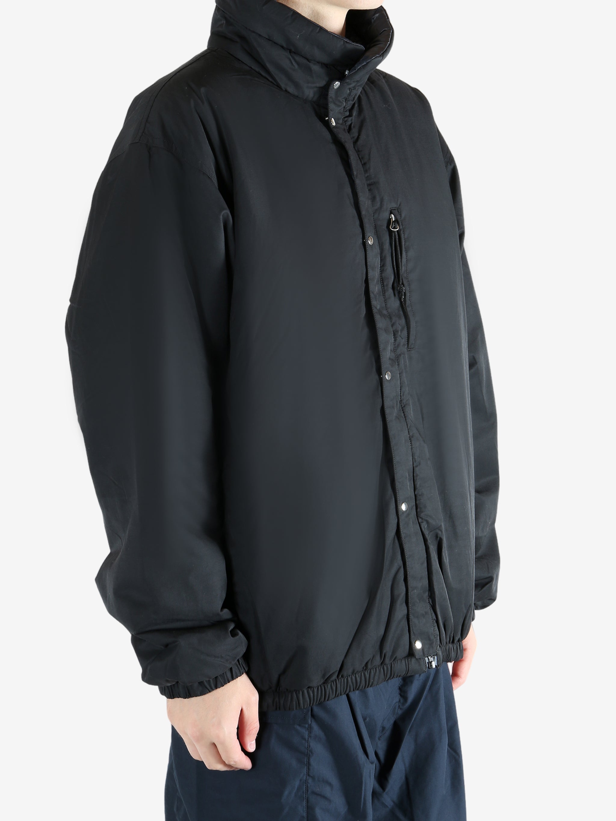 Black jacket worn by a person, showing the jacket's fit