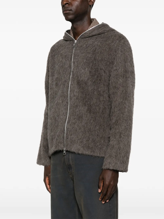 grey hoodie worn by a person, showing the hoodie fit
