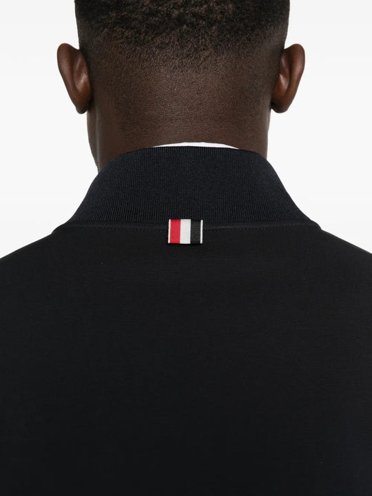 Black jacket worn by a person, showing the jacket fit