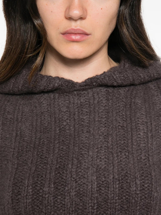 Brown knitwear worn by a person, showing the knitwear fit