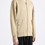 Tan jacket worn by a person, showing the jacket fit