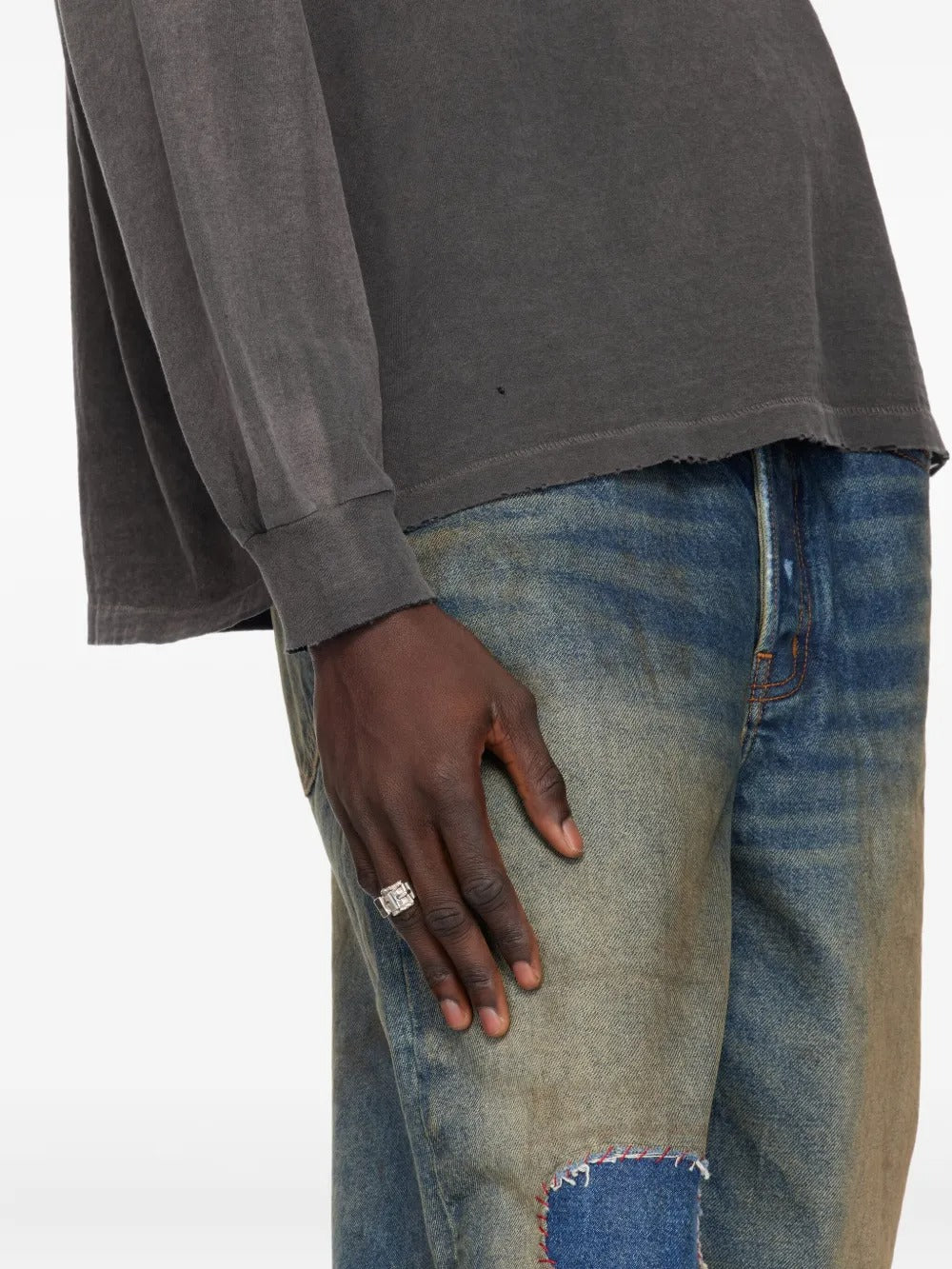 Silver ring worn by a person, showing the ring's fit